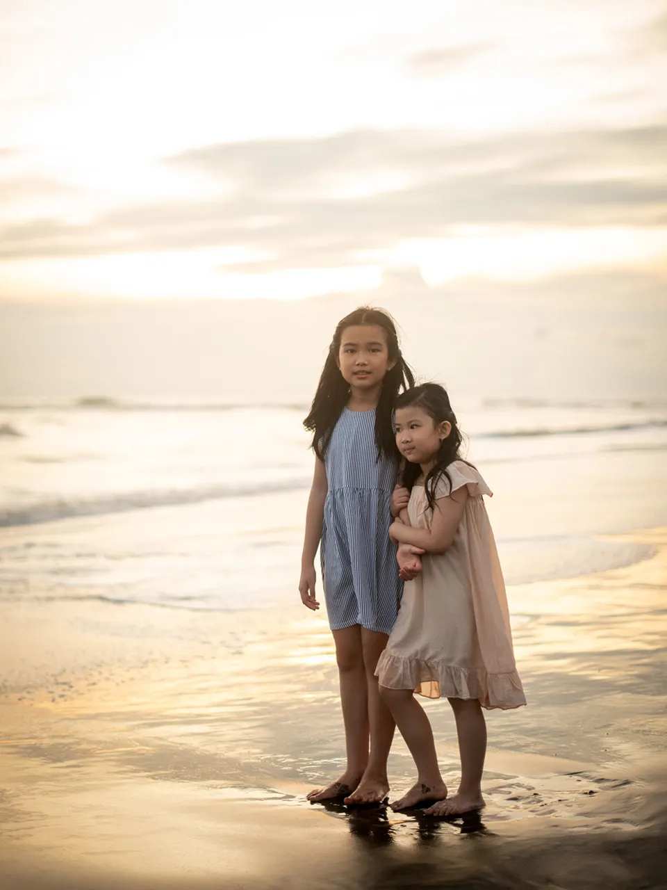 Two family members embracing on the beach