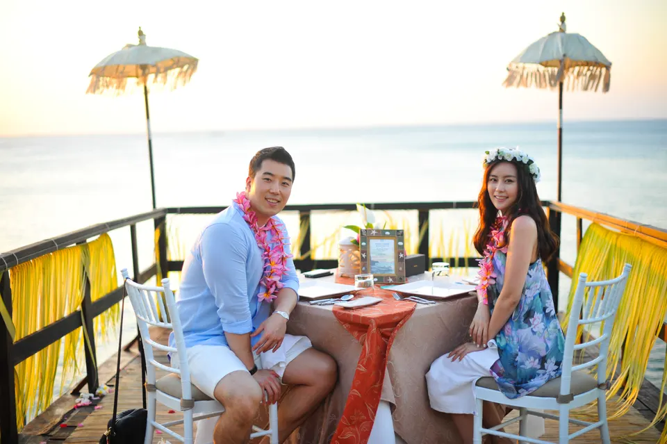 Couple sitting together at a seaside table