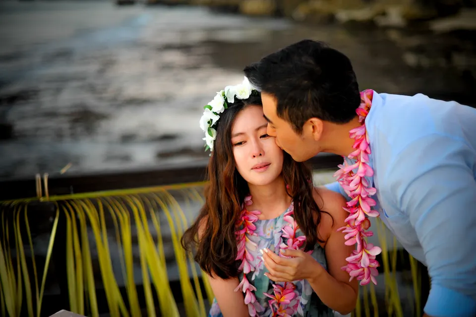 A couple sharing a kiss beside the sea