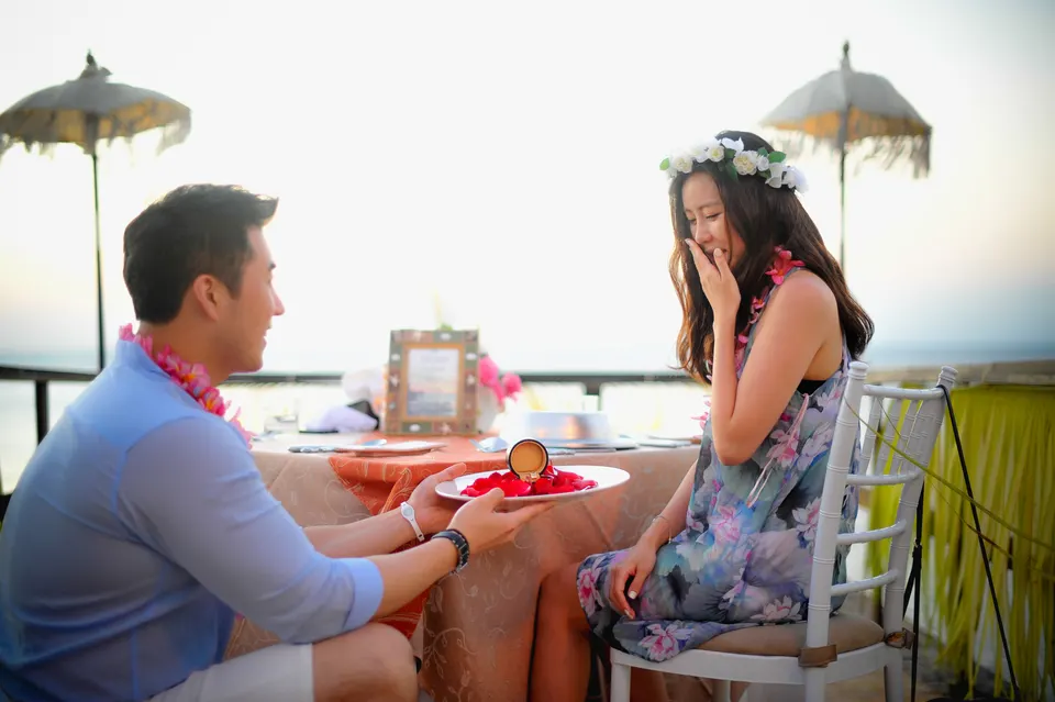 Couple celebrating an engagement at sunset
