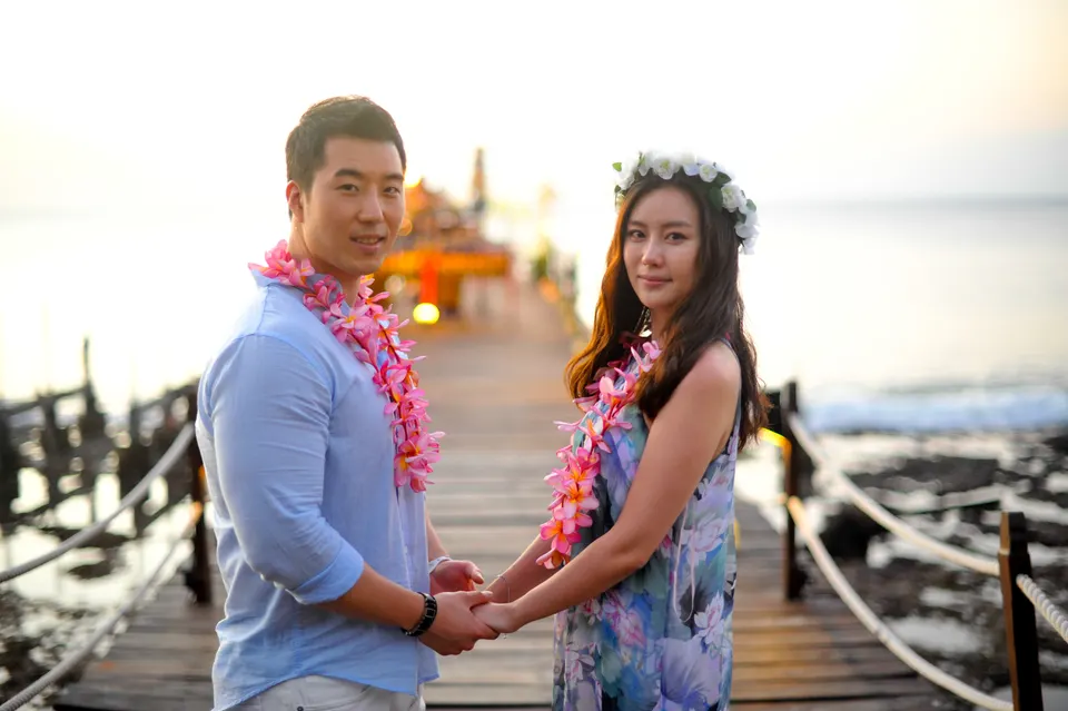 Couple holding hands beside the sea