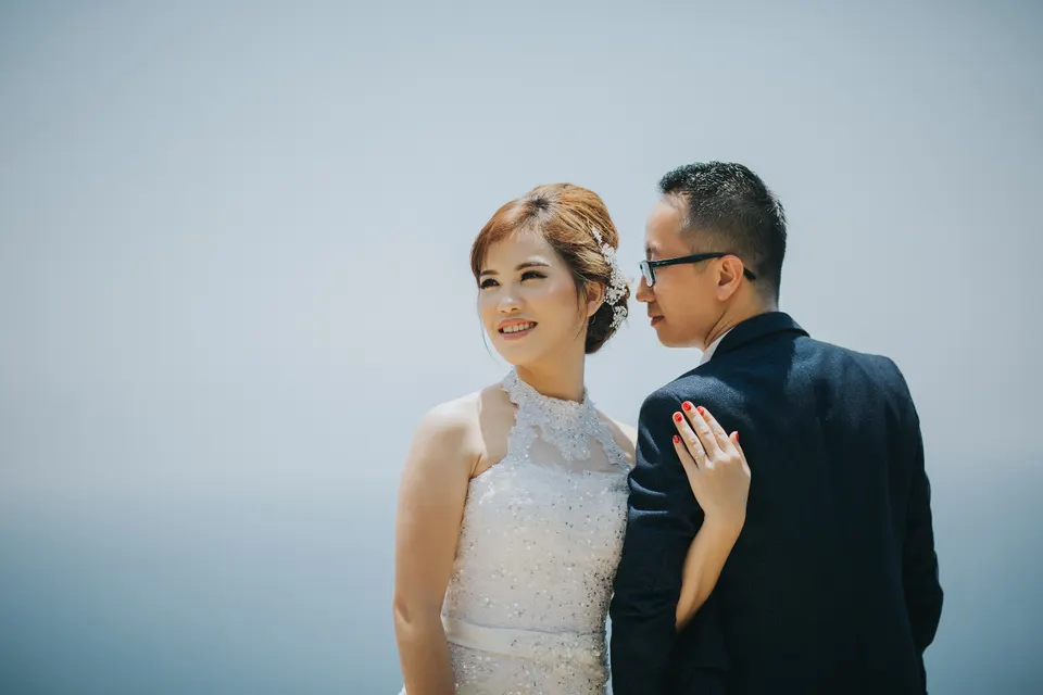 Close-up couple portrait against a blue sky